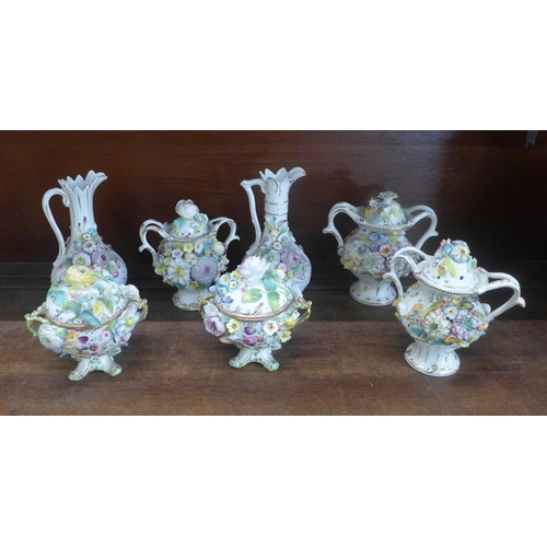 670 - A collection of floral encrusted lidded pots and two jugs, some a/f