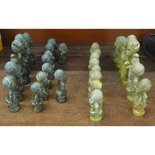 706 - An African carved soapstone chess set