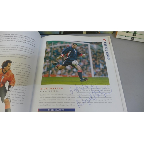 748 - Football:- three World Cup related books containing signatures from former players including Sol Cam... 