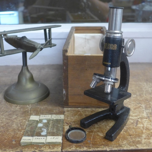 786 - A Milbro microscope and brass model of a bi-plane