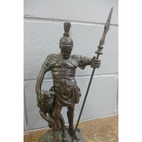 791 - A bronze figure of a Roman Centurion and lion, 42cm