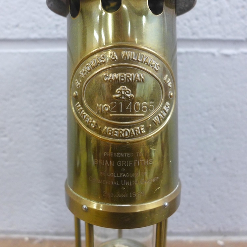 798 - A miner's safety lamp with long service engraving, an ice pick, horn, scales and a brass instrument