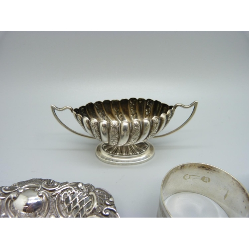 829 - A silver salt, Birmingham 1896, a silver embossed dish, Birmingham 1902, 49g of silver, and a pair o... 