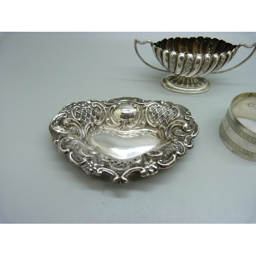 829 - A silver salt, Birmingham 1896, a silver embossed dish, Birmingham 1902, 49g of silver, and a pair o... 