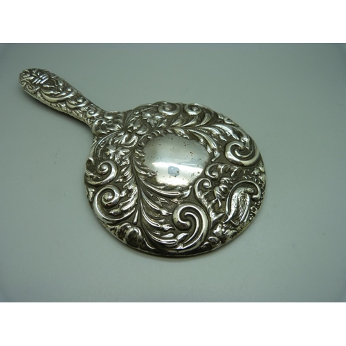 830 - A silver backed hand mirror, Birmingham marks