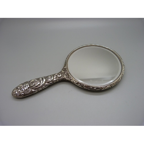 830 - A silver backed hand mirror, Birmingham marks