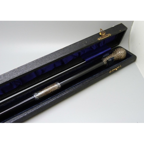 833 - A silver mounted conductor's baton, London 1914, cased, with inscription, 51cm