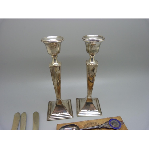 834 - A pair of silver candlesticks, a silver napkin ring, two silver spoons, a metal and horn scent bottl... 