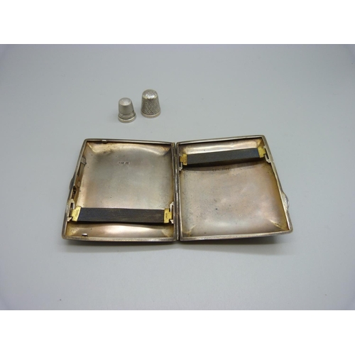 837 - A silver cigarette case, with monogram, 84g, a silver thimble and one other thimble