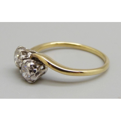 913 - An 18ct gold two stone diamond crossover ring, K, 2.6g, total diamond weight approximately 0.6cts