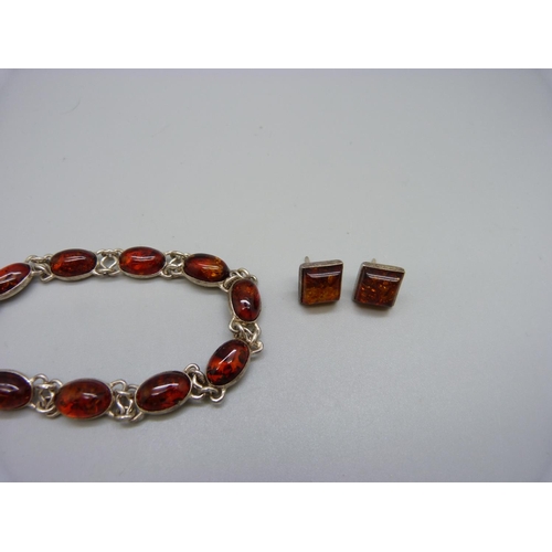 929 - A silver and amber bracelet, ring and earrings