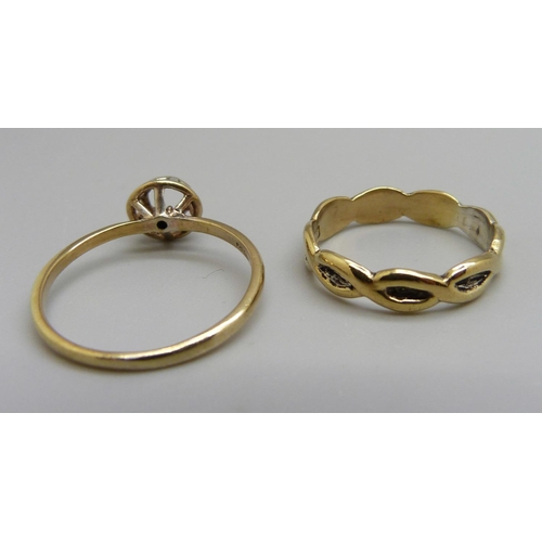 955 - Two silver gilt rings, one with a diamond centre stone, P and U