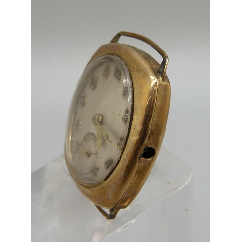 980 - A 9ct gold cased wristwatch head, the movement marked Visible, weight of case back 3.9g, lacking cro... 