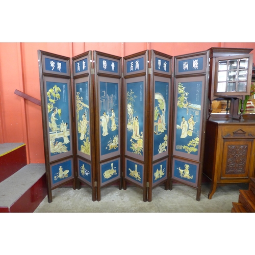 11 - A Chinese mahogany and blue chinoiserie decorated six panel folding screen