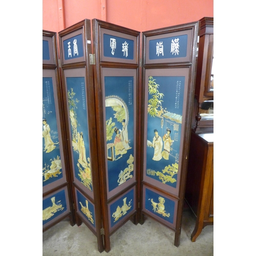 11 - A Chinese mahogany and blue chinoiserie decorated six panel folding screen