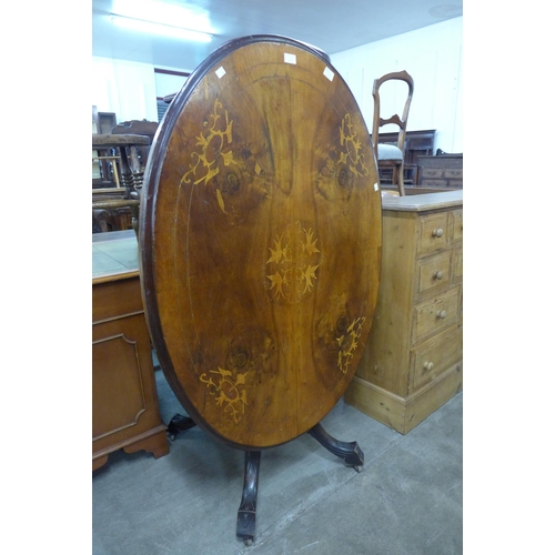 112 - A Victorian inlaid walnut oval tilt top loo table