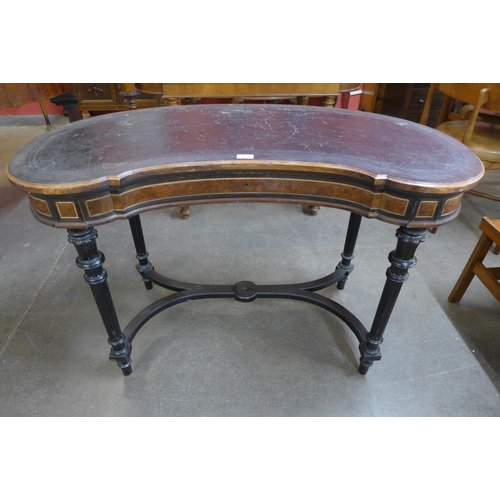 116B - A Victorian Gillows ambonya, ebonised and leather topped kidney shaped writing table