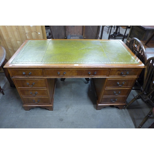 122 - A yew wood and green leather topped desk