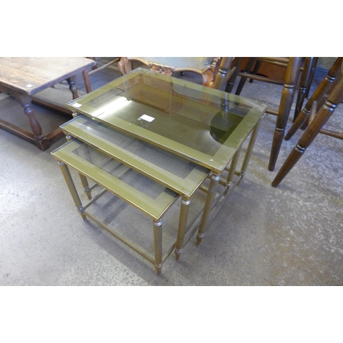 141 - An Italian brass and glass topped nest of tables