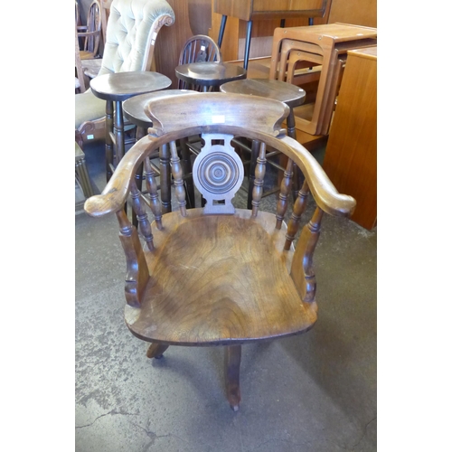 145 - A Victorian elm and beech revolving Captains desk chair