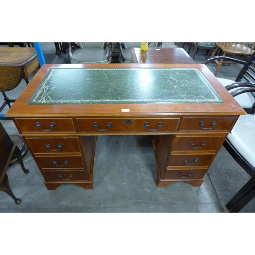 184 - A mahogany and green leather topped pedestal desk