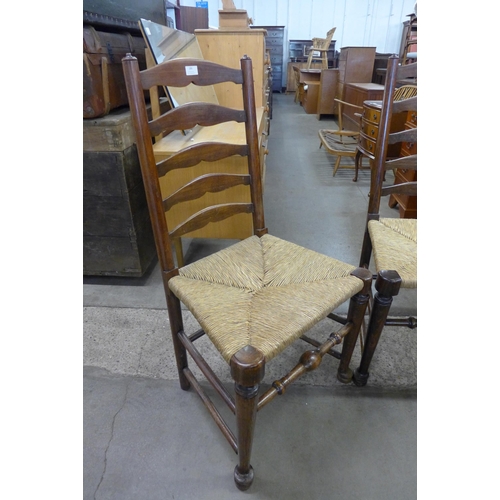 186 - A set of four George III style elm and beech ladderback chairs