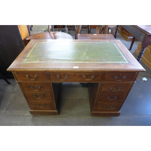 197 - A Victorian mahogany and green leather topped pedestal desk