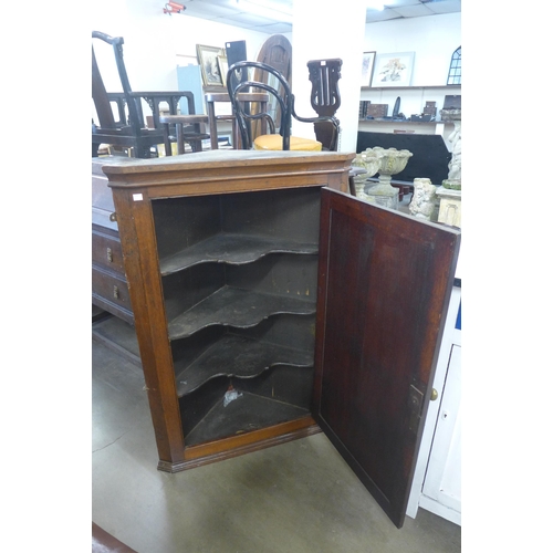 206 - A George III oak wall hanging corner cupboard