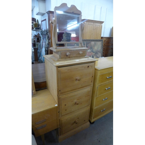 208 - A pine three drawer chest and a pine toilet mirror