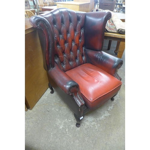 222a - An oxblood red Chesterfield wingback armchair