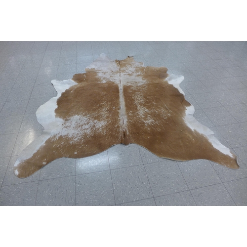 224 - A cow hide rug