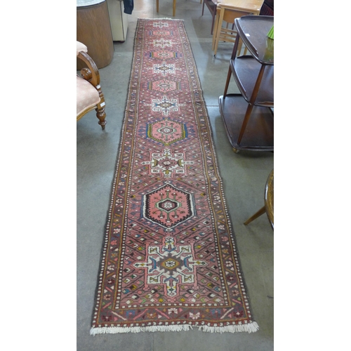 226 - A Persian salmon pink ground runner rug