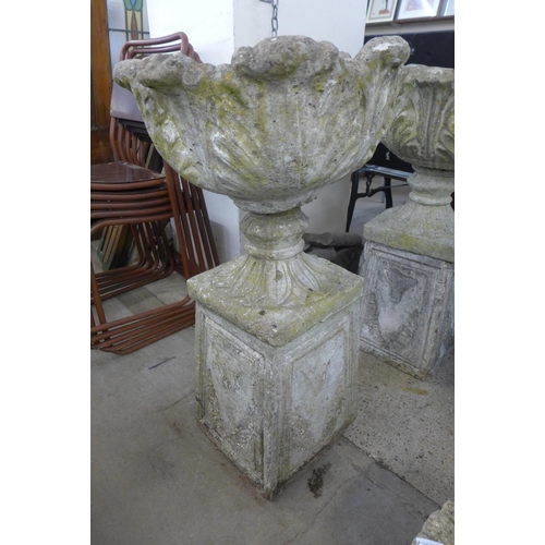 250 - A pair of concrete garden urns on stands