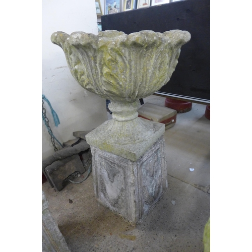 250 - A pair of concrete garden urns on stands