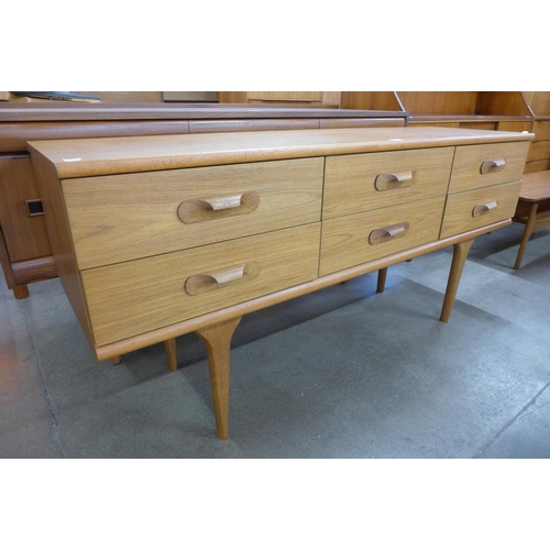 45 - An Austin Suite teak six draw sideboard