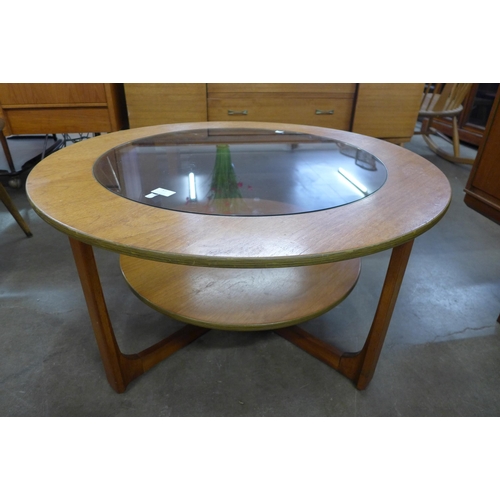 57 - A teak and glass topped circular coffee table