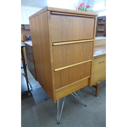 58 - A teak chest of drawers on chrome stand