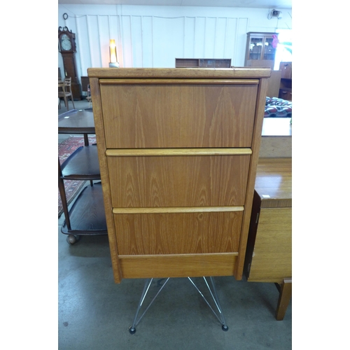 58 - A teak chest of drawers on chrome stand