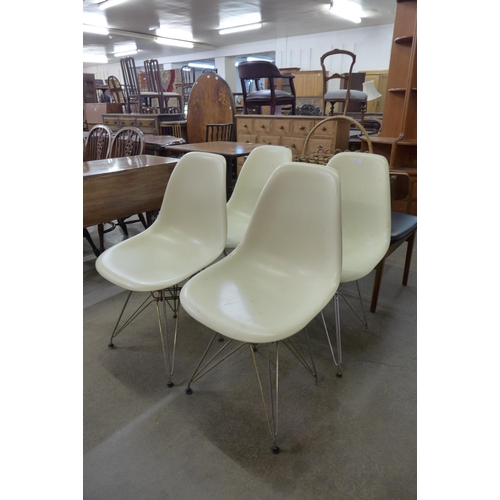 77 - A set of four Eames style white perspex and chrome Eiffel chairs