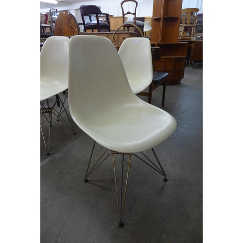 77 - A set of four Eames style white perspex and chrome Eiffel chairs