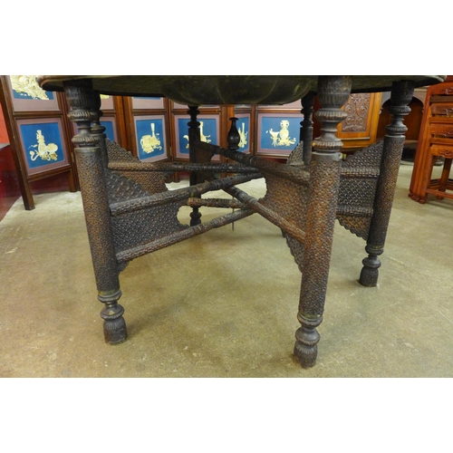 9 - An Anglo-Indian carved hardwood and brass topped occasional table