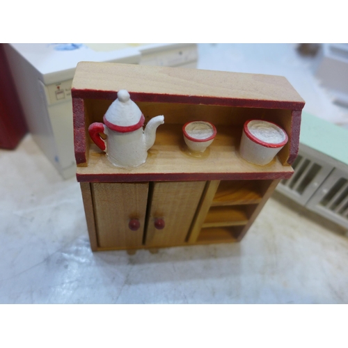 2185 - Approx 40 items of dolls house furniture in red leather-effect storage box