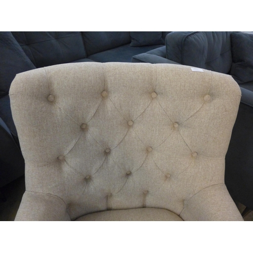 1311 - A beige fabric button back armchair