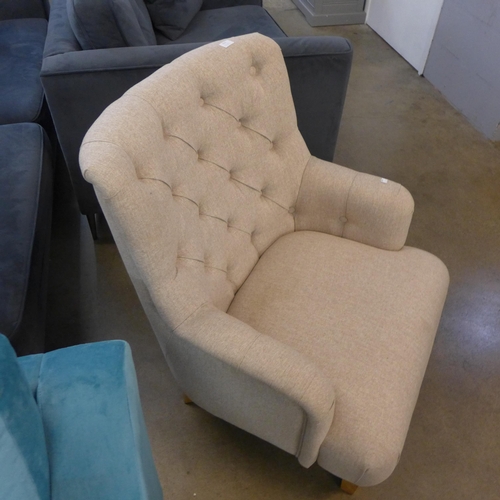 1311 - A beige fabric button back armchair