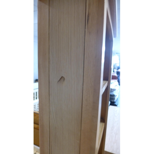 1576 - A Rutland oak slim tall bookcase (damaged left side)