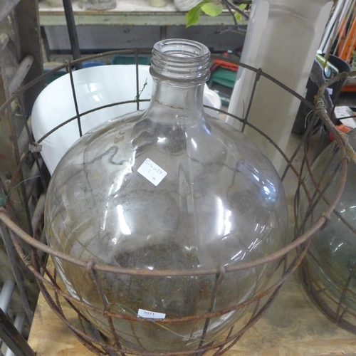 2071 - Glass carboy jar in metal cage