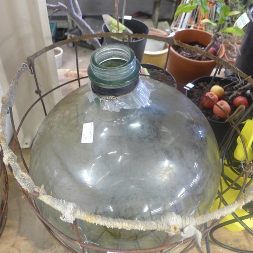 2072 - Glass carboy jar in metal cage