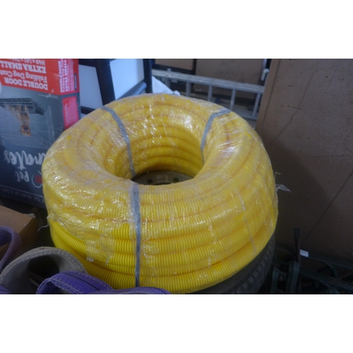 2243 - Crate of lifting straps, Ford transit van wheel and reel of yellow ducting/flexible 40mm conduit pip... 