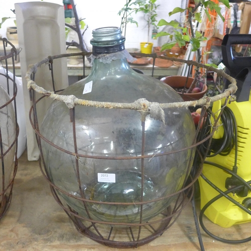 2072 - Glass carboy jar in metal cage