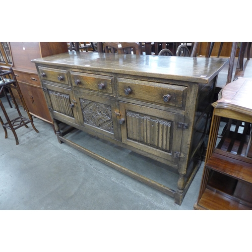 99 - An Elizabethan Revival carved oak dresser